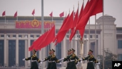 Chinese soldiers march to their post outside the Great Hall of the People in Beijing, March 7, 2025. 