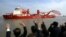 FILE - Relatives and friends of researchers and crew members wave as Xue Long (Snow Dragon) leaves the port on an Antarctica research mission in Shanghai.