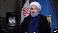 FILE - Iranian President Hassan Rouhani addresses the nation from Tehran, Aug. 6, 2018. Iran has increased its offensive cyberattacks against the U.S. government and critical infrastructure as tensions have grown between the two nations, experts say.