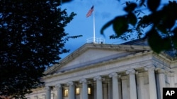 FILE - The US Treasury Department building is seen at dusk in Washington, June 6, 2019. 