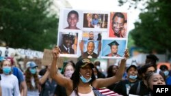 Demonstrators march near the White House, to protest police brutality and racism, on June 10, 2020 in Washington, DC. - Demonstrations are being held across the US following the death of George Floyd on May 25, 2020, while being arrested in…