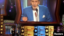 FILE - Legendary comedian Sid Caesar accepts the TV Land Pioneer award presented by friend and comedian Billy Crystal (L) during a taping of the TV Land awards show in Santa Monica, California, in 2006.