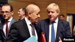 Britain's Foreign Secretary Boris Johnson talks with French Minister for Foreign Affairs Jean-Yves Le Drian during European Union foreign ministers meeting in Luxembourg, April 16, 2018.