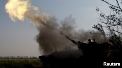 FILE: Ukrainian servicemen fire a self-propelled howitzer toward Russian positions on a frontline in Mykolaiv region. Taken November 2, 2022