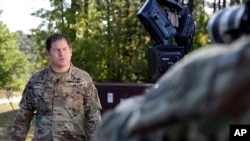 U.S. Army Major Brian Minietta records a weekly Facebook message outside the headquarters of the 3rd Special Forces Group at Fort Bragg, N.C., April 16, 2020
