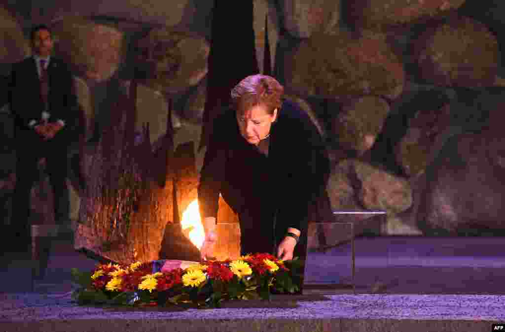 German Chancellor Angela Merkel lays a wreath in the Hall of Remembrance at the Yad Vashem Holocaust Museum in Jerusalem.