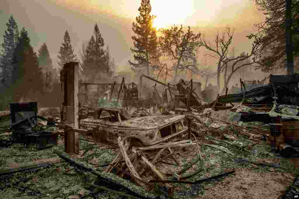 A vintage car rests among debris as the Camp Fire tears through Paradise, Calif., on Nov. 8, 2018. 