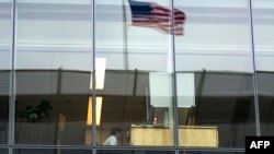 FILE - An office worker sits at his desk at a bank in Washington, D.C., May 5, 2016.