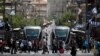 FILE - Pedestrians cross a street next to the light rail trams in Jerusalem, May 11, 2017. Rights groups are criticizing the involvement of French companies in the building of another tram that connects to Israeli settlements. 