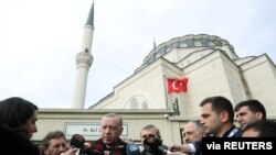 FILE - Turkish President Recep Tayyip Erdogan talks to journalists in Istanbul, Turkey, Feb. 21, 2020.