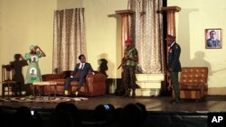 FILE: In this photo taken March, 28, 2018, actor Caroline Magenga, playing former Zimbabwean first lady Grace Mugabe, left, reacts as armed soldiers enter her house during a play dramatizing the events leading to Mugabe's resignation, in Harare, Zimbabwe.