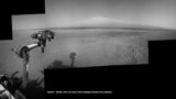 The Mars Curiosity rover's robotic arm takes aim at Mount Sharp in a mosaic that combines navigation-camera imagery from Sols 2, 12 and 14 (Aug. 8, 18 and 20). The shadow of the rover's camera mast is visible in the center foreground.