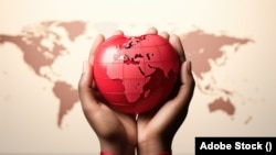 Hands tied with a red ribbon hold the globe. World AIDS Day. Advertising banner