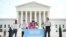 FILE - Deferred Action for Childhood Arrivals (DACA) demonstrators stand outside the U.S. Supreme Court in Washington, June 15, 2020. 