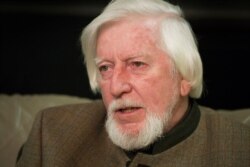 FILE - Puppeteer Caroll Spinney is interviewed during a break from taping an episode of "Sesame Street" in New York, April 10, 2008.