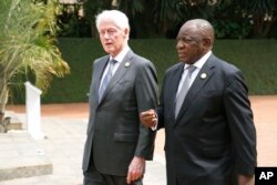 FILE—Former US President Bill Clinton, left, and South Africa's President Cyril Ramaphosa arrive to lay a wreath at a ceremony to mark the 30th anniversary of the Rwandan genocide, held at the Kigali Genocide Memorial, in Kigali, Rwanda, April 7, 2024.