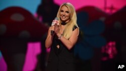 FILE - Britney Spears introduces Miley Cyrus at iHeartRadio Music Festival, day 2, Sept. 21, 2013, in Las Vegas, Nevada. 