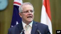 In this Feb. 10, 2020, file photo, Australia's Prime Minister Scott Morrison makes a joint statement with Indonesia's President Joko Widodo at Parliament House in Canberra, Australia. 