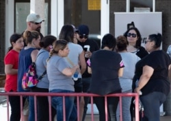 Relatives of victims of the Walmart mass shooting wait for information from authorities at the reunification center in El Paso, Texas, Aug. 4, 2019.