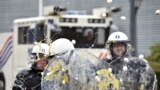 Eggs are thrown at policemen as farmers and dairy farmers from all over Europe take part in a demonstration, calling for more help with low prices and high costs, outside an emergency meeting of European Union farm ministers at the EU Council headquarters in Brussels, Belgium.