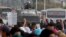 Protesters gesture with four fingers after blocking Al Nasr street in front of Al-Azhar University headquarters at Cairo's Nasr City district, Nov. 19, 2013. 