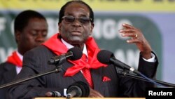 FILE: Zimbabwe President Robert Mugabe addresses people gathered for his 91st birthday celebration in Victoria Falls, Feb. 28, 2015. 