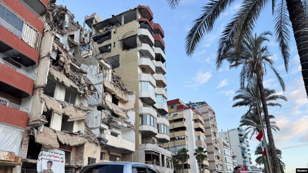 Cars go past a damaged building in Tyre, Lebanon, Jan. 24, 2025. 