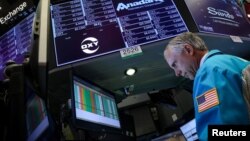 Specialist trader Don Himpele Jr. works at the post that trades Anadarko Petroleum and Occidental Petroleum on the floor at the New York Stock Exchange (NYSE) in New York, April 30, 2019.