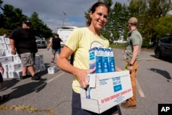 Volunteers stage water for citizens in the aftermath of Hurricane Helene, Sept. 30, 2024, in Asheville, NC.