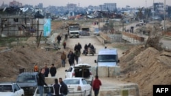 Displaced Palestinians cross the Netzarim corridor as they make their way to the northern parts of the Gaza Strip on Feb. 9, 2025.