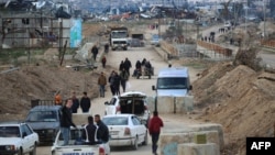 Displaced Palestinians cross the Netzarim corridor as they make their way to the northern parts of the Gaza Strip on February 9, 2025.