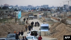 Displaced Palestinians cross the Netzarim corridor as they make their way to the northern parts of the Gaza Strip on Feb. 9, 2025.