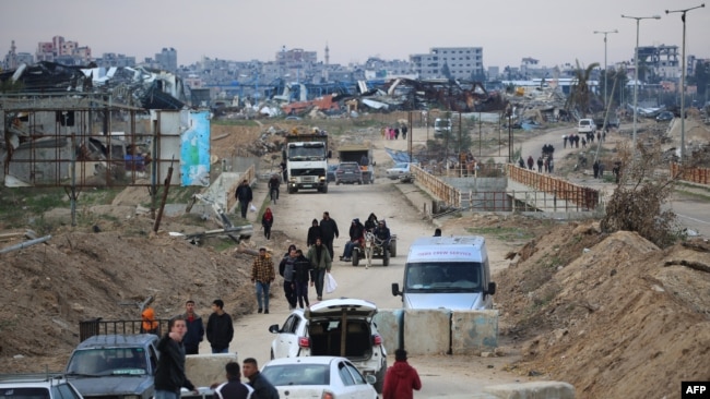 Displaced Palestinians cross the Netzarim corridor as they make their way to the northern parts of the Gaza Strip on Feb. 9, 2025.