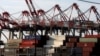 FILE - Containers are stacked beneath cranes at Port Newark Container Terminal in Newark, New Jersey. 