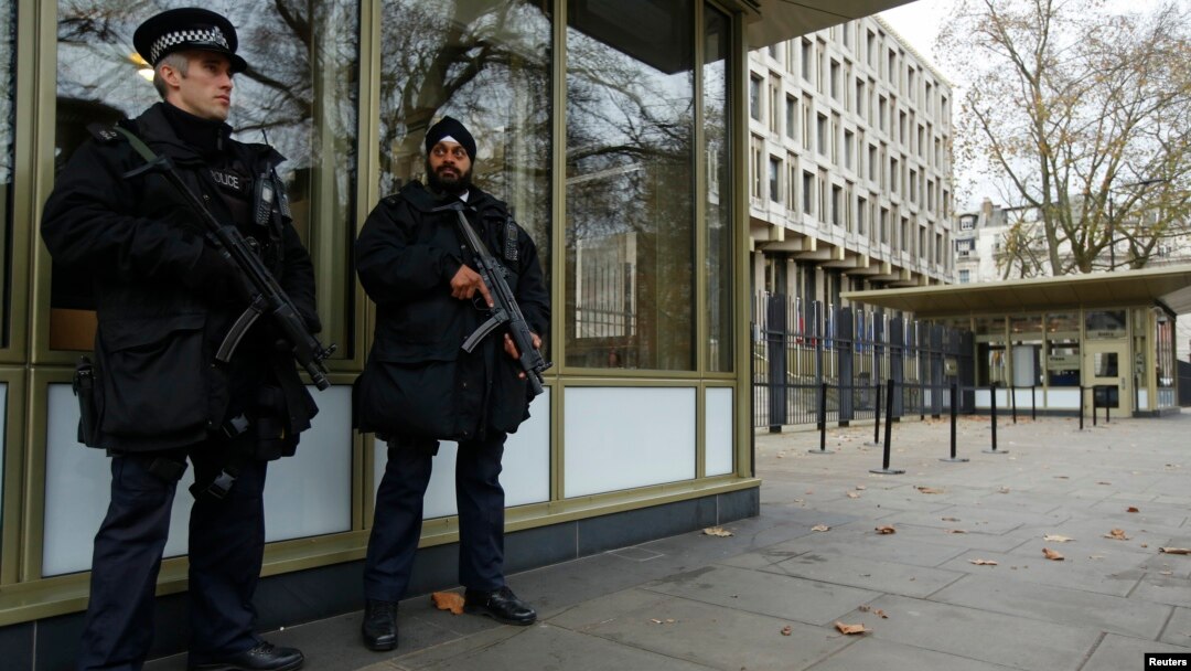 FILE - Police officers are seen patrolling outside the U.S. Embassy in London in a Dec. 9, 2014, photo.