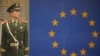 FILE - A Chinese paramilitary policeman stands guard outside the European Union Delegation in Beijing, Nov. 1, 2011.