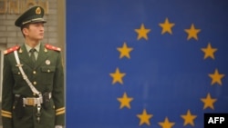 FILE - A Chinese paramilitary policeman stands guard outside the European Union Delegation in Beijing, Nov. 1, 2011.