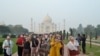 Foreign tourists wearing face masks visit the Taj Mahal under heavy smog conditions, in Agra, India. As smog levels exceeded those of Beijing by more than three times, authorities also parked a van with an air purifier near the iconic 17th-century marble mausoleum in a bid to clean the air, the Press Trust of India reported.