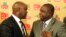 FILE - Kirsten Nematandani, president of the South African Football Association (R) shakes hands with then coach for South Africa's national soccer team Pitso Mosimane, in Johannesburg, South Africa, July 15, 2010.
