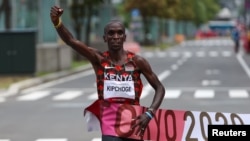 FILE - Eliud Kipchoge of Kenya crosses the finish line to win gold in the men's marathon at the Tokyo 2022 Olympics, in Sapporo, Japan, on Aug. 8, 2021.