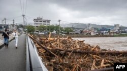 Debris from floodwaters is seen stuck by a bridge following heavy rain in Wajima city, Ishikawa prefecture, Japan, on Sept. 22, 2024.