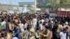 FILE - People try to get into Hamid Karzai International Airport in Kabul, Afghanistan, Aug. 16, 2021.