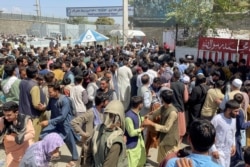 People try to get into Hamid Karzai International Airport in Kabul, Afghanistan, Aug. 16, 2021.