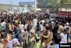 People try to get into Hamid Karzai International Airport in Kabul, Afghanistan, Aug. 16, 2021.
