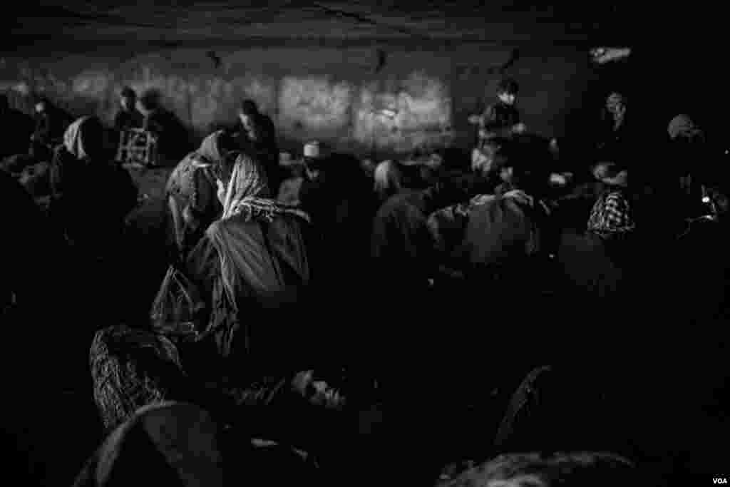 Drug users sitting next to a tent under the bridge in Pul-e-Sukhta area - the only home some of them have. (Maciej Stanik/VOA)