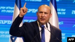FILE - Naftali Bennett, leader of Israel's Yamina (New Right) party, addresses supporters at his party's campaign headquarters in the Mediterranean coastal city of Tel Aviv, March 24, 2021.