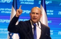 FILE - Naftali Bennett, leader of the Israeli right-wing Yamina (New Right) party, addresses supporters at his party's campaign headquarters in Tel Aviv, March 24, 2021.