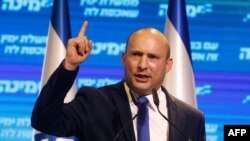 FILE - Naftali Bennett, leader of Israel's Yamina (New Right) party, addresses supporters at his party's campaign headquarters in the Mediterranean coastal city of Tel Aviv, March 24, 2021.