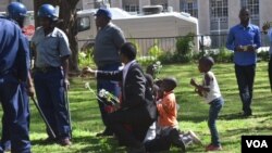 FILE: Sten Zvorwadza attempting to handover flowers to police recently.