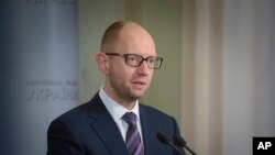 Perdana Menteri sementara Ukraina Arseniy Yatsenyuk menjawab pertanyaan media setelah sesi parlemen darurat di Kyiv, Ukraina (2/3). (AP/Andrew Kravchenko)